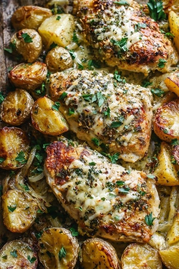 Juicy Garlic Parmesan Chicken and crispy roasted potatoes cooked on one pan, topped with melted Parmesan and fresh herbs.”