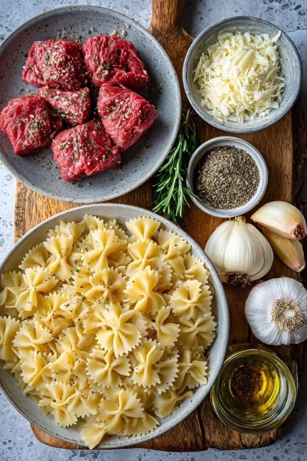 Garlic Butter Bowtie Pasta with Beef Perfection ingredients arranged on a countertop.